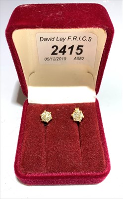 Lot 2415 - A pair of diamond stud earrings, each with a...