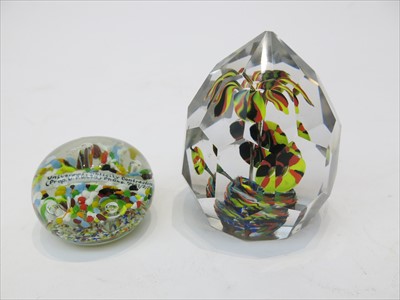 Lot 1484 - Two coloured glass paperweights. Largest...